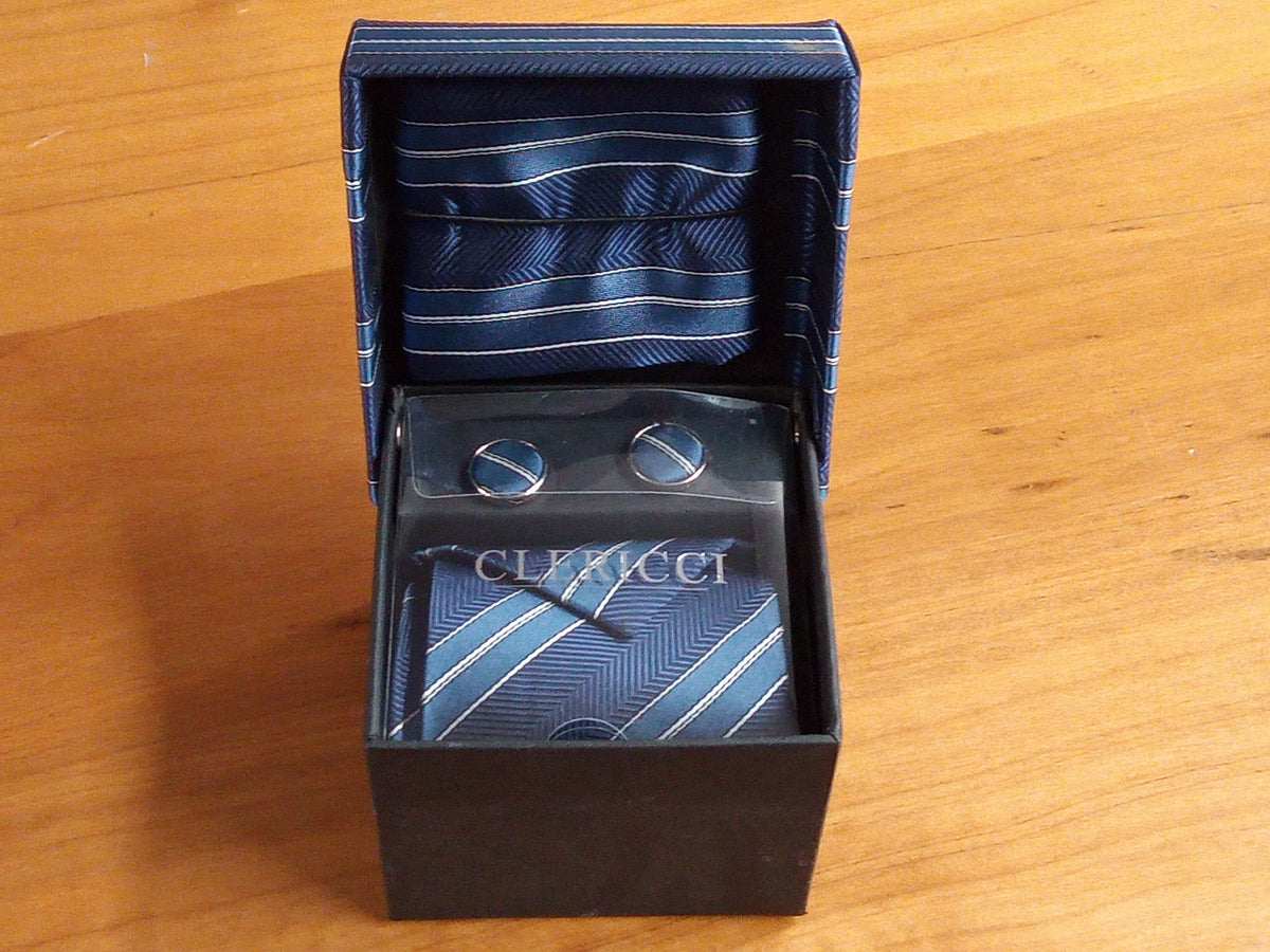 a tie and cufflinks in a box on a table