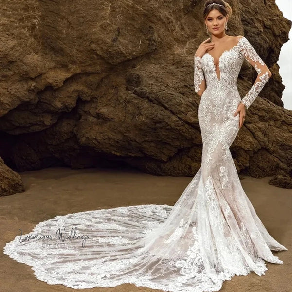 a woman in a wedding dress standing on a beach