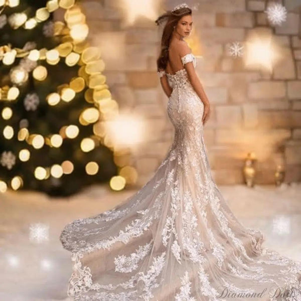 a woman in a wedding dress standing in front of a christmas tree