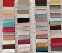 a bunch of different colors of fabric on a table