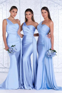 three women in blue dresses standing next to each other