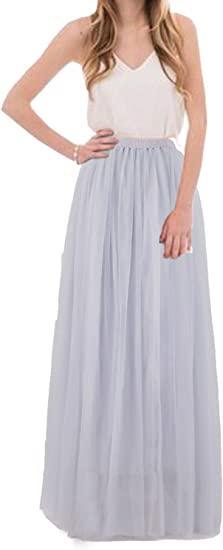a woman wearing a long skirt with a white tank top